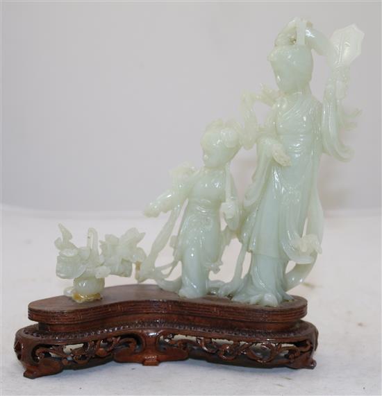 A Chinese pale celadon jade group of a lady and a girl with flowing robes, a basket beside them, 20th century, total height 19cm